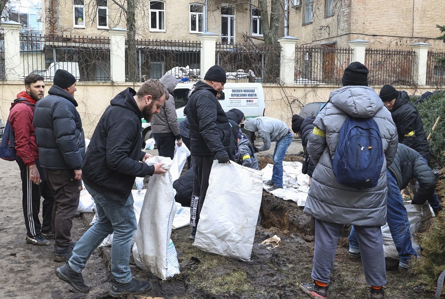 epa09789530 Ukrainians fill the bags by sand and soil for a wall in the city of Kharkiv, Ukraine, 27 February 2022. Russian troops entered Ukraine on 24 February prompting the country&#039;s president ...