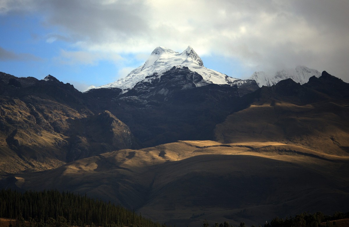 The Vallunaraju mountain stands high in the Andes, early morning in Huaraz, Peru, Wednesday, Dec. 3, 2014. Peru's glaciers have lost more one-fifth of their mass in just three decades, and the 70 ...