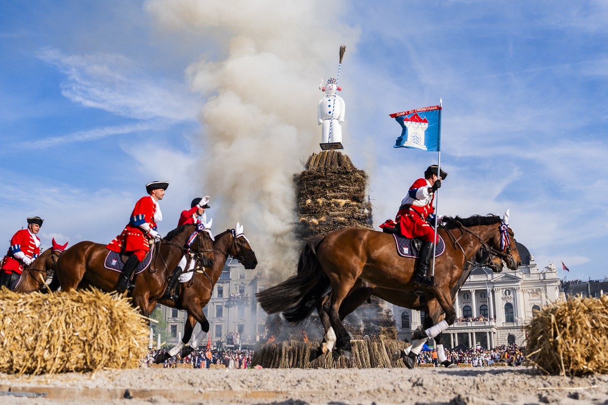Horse riders ride next to the burning "Boeoegg" on the Sechselaeuten place in Zurich, Switzerland, pictured on April 28, 2025. The Sechselaeuten (ringing of the six o'clock bells) is a  ...