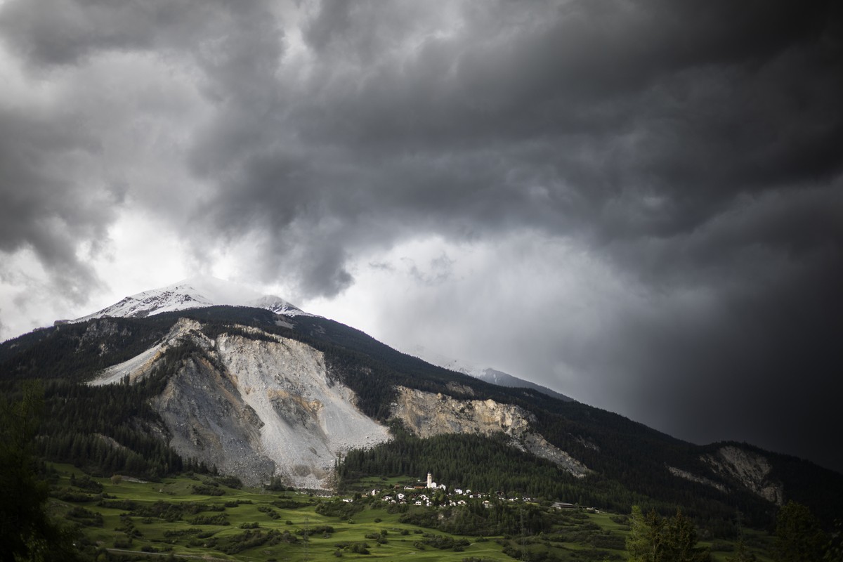 epa10623062 The village of Brienz/Brinzauls beneath the "Brienzer Rutsch", in Graubuenden, Switzerland, 12 May 2023. Two million cubic metres of rock from the mountain above the village are  ...