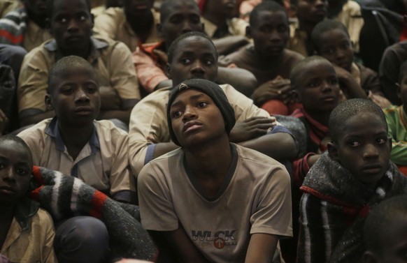 FILE - In this Dec. 18, 2020 file photo, some of the schoolboys who were kidnapped from the all-boys Government Science Secondary School in Katsina state sit together following their release in Katsin ...