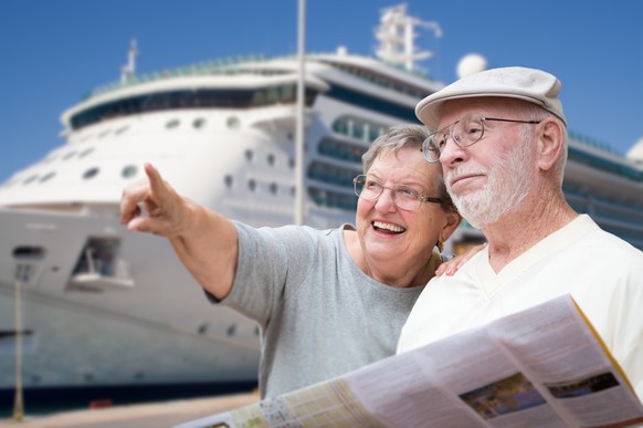 Happy Senior Adult Couple Tourists with Brochure Next To Passenger Cruise Ship., Happy Senior Adult Couple Tourists with Brochure Next To Passenger Cruise Ship. model released, Symbolfoto , 06.06.2021 ...