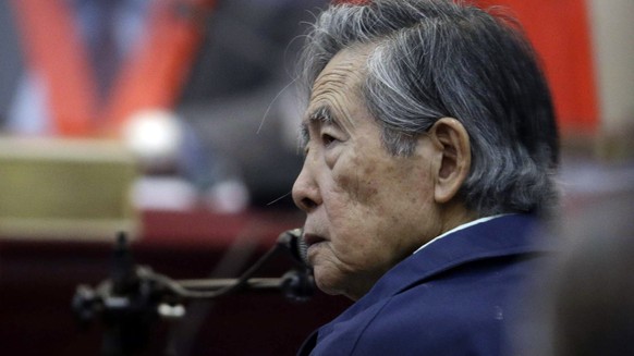 FILE - Peru&#039;s former President Alberto Fujimori listens to a question during his testimony in a courtroom at a military base in Callao, Peru, March 15, 2018. The South American country ?s Constit ...