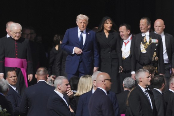 President Donald Trump and first lady Melania Trump, center, and other guests arrive, for the funeral of Pope Francis in St. Peter&#039;s Square at the Vatican, Saturday, April 26, 2025. (AP Photo/And ...
