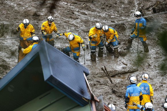 Rescuers continue a search operation at the site of a mudslide at Izusan in Atami, Shizuoka prefecture, southwest of Tokyo Monday, July 5, 2021. (Kyodo News via AP)