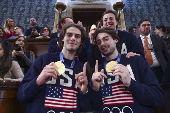 epa12775115 Team USA Mens Hockey Jack and Quinn Hughes (R), with their teammates, pose for a photo as US President Donald Trump delivers his State of the Union address before a joint session of Congr ...