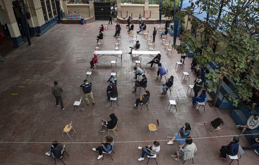 Teachers wait to get the CoronaVac vaccine for COVID-19, by China���s Sinovac Biotech, at Salvador Sanfuentes public school during the start of nationwide vaccinations for educators in Santiago, Chile ...