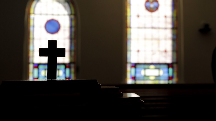 ADVANCE FOR TUESDAY, DEC. 5, 2017 - A cross stands in New Hope United Methodist Church as Rev. Shawn Mitchell, a Navy combat veteran, stands in the sanctuary in Rowland, N.C., Friday, Oct. 27, 2017. & ...