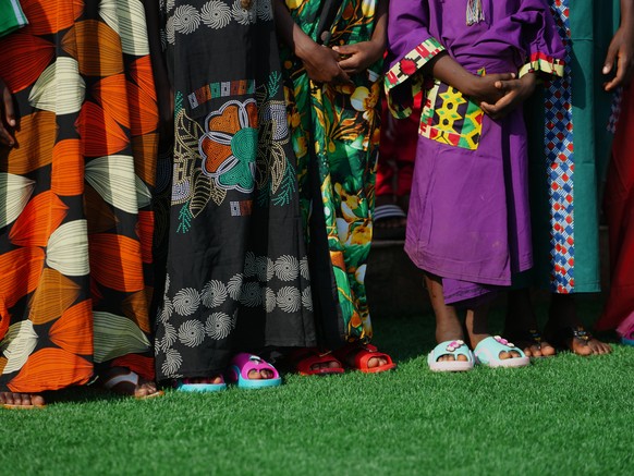 Freed students of St. Mary's Catholic School in the Papiri community pose for photographs upon their arrival at the government house, in Minna, Nigeria, Monday, Dec. 22, 2025. (AP Photo/Sunday Al ...