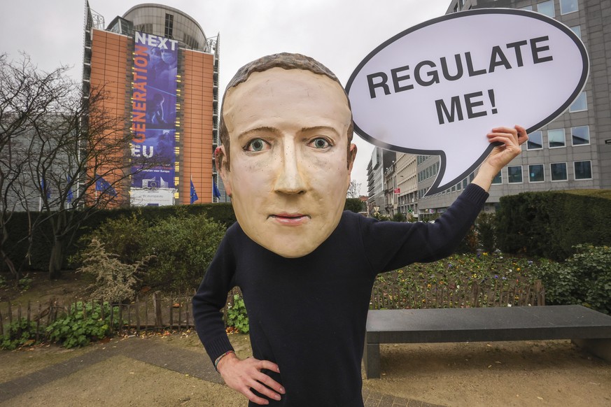 IMAGE DISTRIBUTED FOR AVAAZ - A campaigner from the global citizens movement Avaaz wearing a mask of Facebook CEO Mark Zuckerberg holds a sign reading &quot;Regulate me&quot;, outside the European Com ...