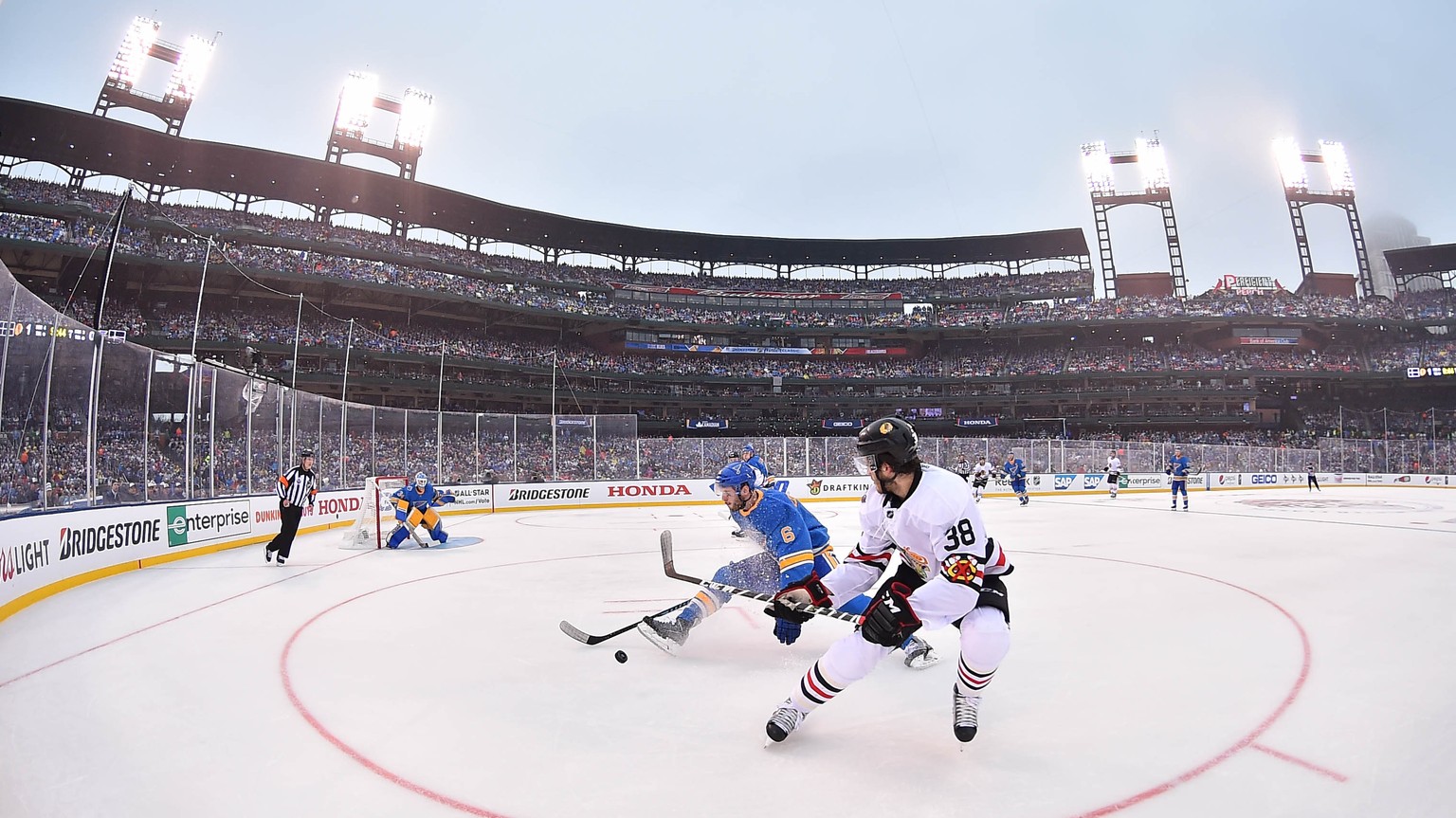 Jan 2, 2017; St. Louis, MO, USA; Chicago Blackhawks right wing Ryan Hartman (38) is defended by St. Louis Blues defenseman Joel Edmundson (6) during the first period in the 2016 Winter Classic ice hoc ...