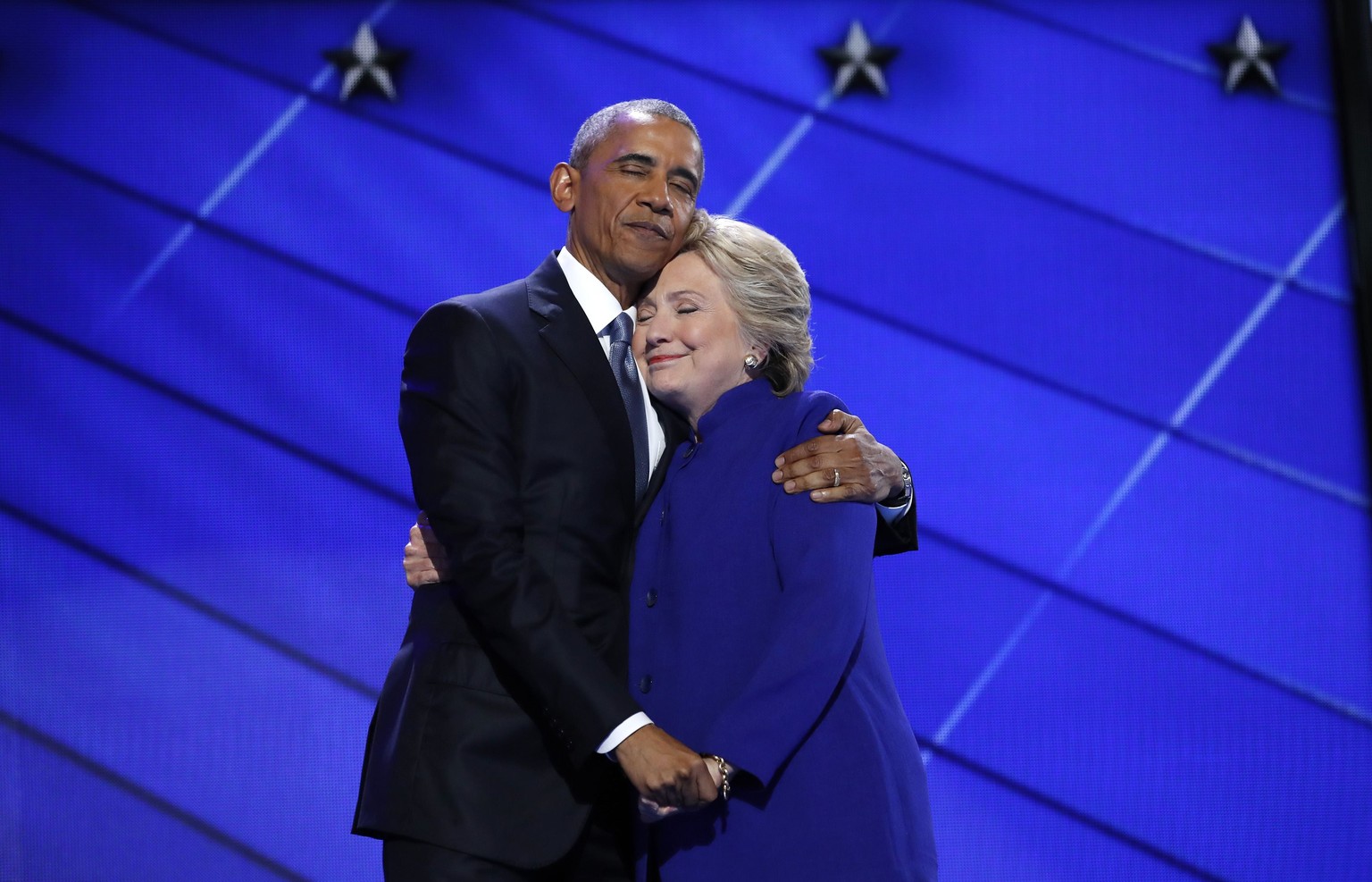 Democratic presidential nominee Hillary Clinton hugs U.S. President Barack Obama as she arrives onstage at the end of his speech on the third night of the 2016 Democratic National Convention in Philad ...