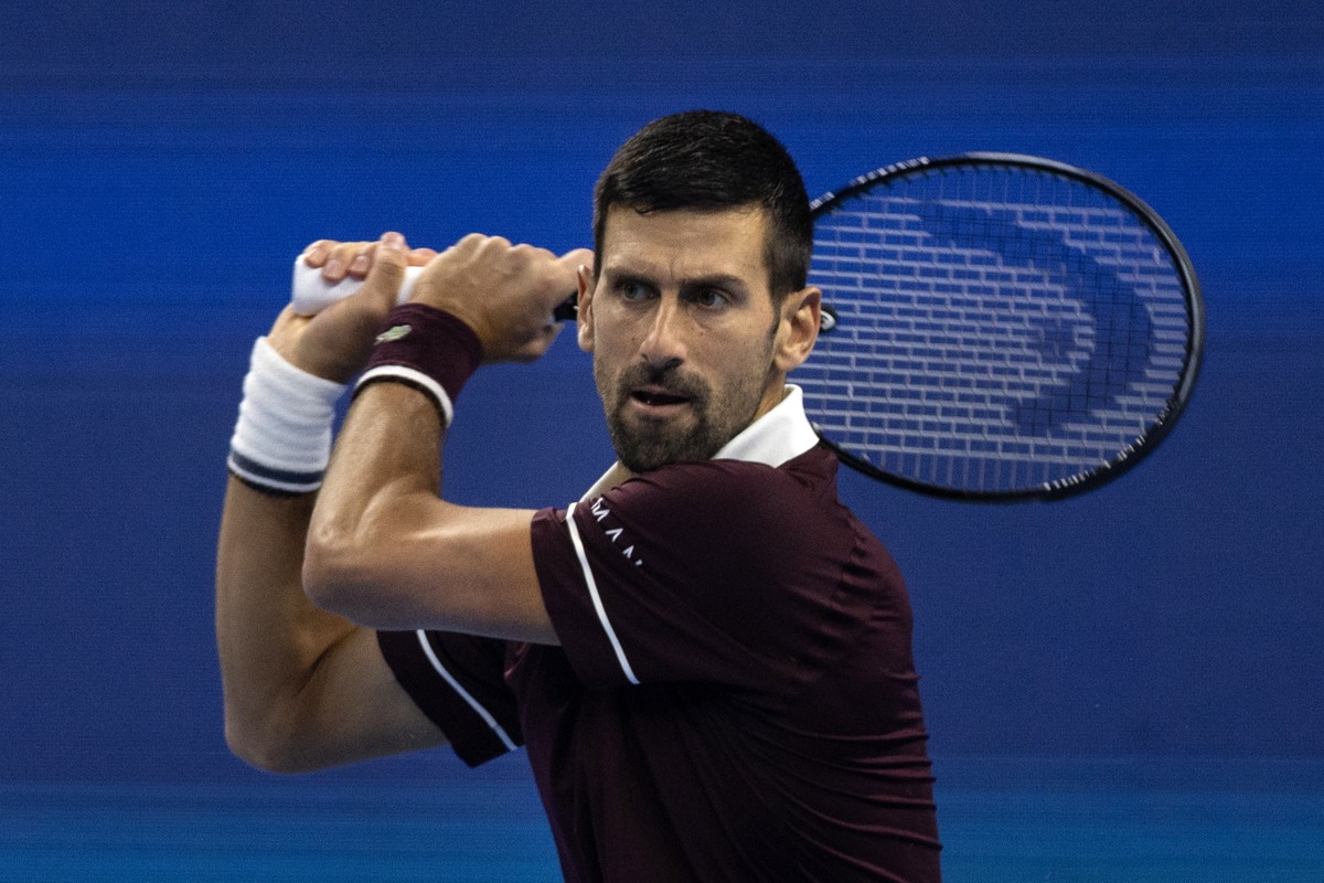 epa13284932 Novak Djokovic of Serbia in action against Alex De Minaur of Australia during their mens Final singles match at the China Open tennis tournament in Beijing, China, 06 October 2026. EPA/JE ...