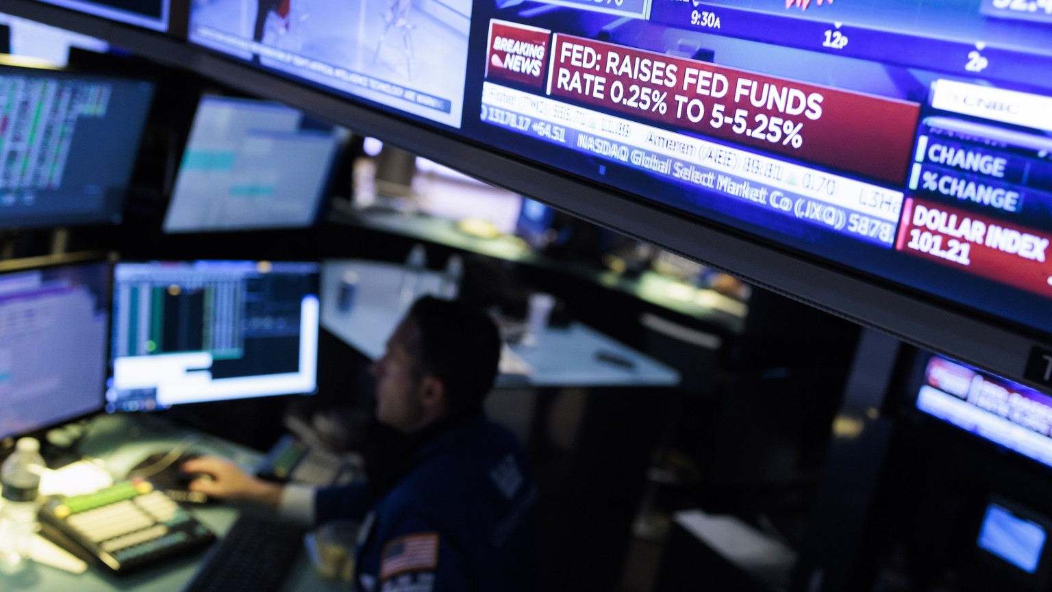 epa10606979 Traders work on the floor during the news about the US Federal Reserve most recent decision about interest rates at the New York Stock Exchange in New York, USA, 03 May 2023. The Federal R ...