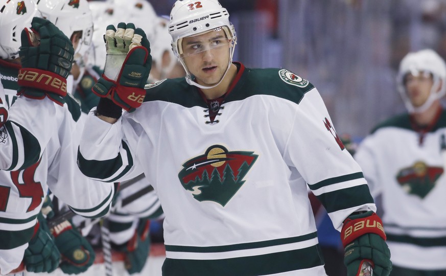 Minnesota Wild right wing Nino Niederreiter, of the Czech Republic, is congratulated as he passes the team box after scoring against the Colorado Avalanche during the third period of an NHL hockey gam ...