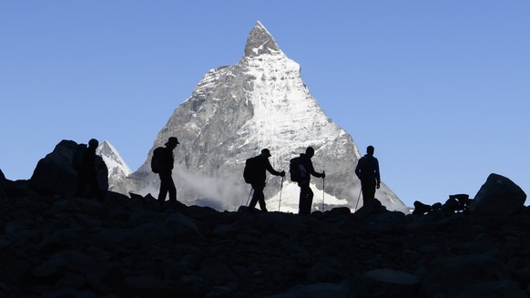 epa09473564 Festival-goers come down after a concert of the French Band Tournee des Refuges the day before at the Monte Rosa Hut (2,883m), with a view of Cervin (Matterhorn) Mountain, during the Zerma ...