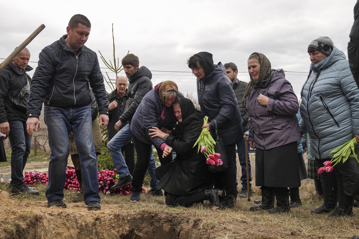 Liudmila Sumanchuk, center in black coat, the grandmother of Veronika Kuts cries during her funeral ceremony in L'giv village, Chernihiv region, Ukraine, Friday April 8, 2022. Veronika Kuts, who  ...