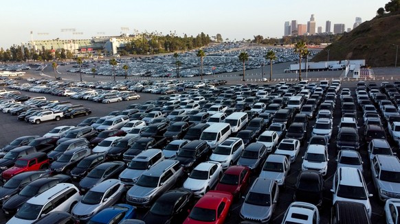 epa08438555 A photo taken with a drone shows rental cars sitting in a parking lot of the Dogers Stadium amid the coronavirus pandemic in Los Angeles, California, USA, 22 May 2020. According to media r ...