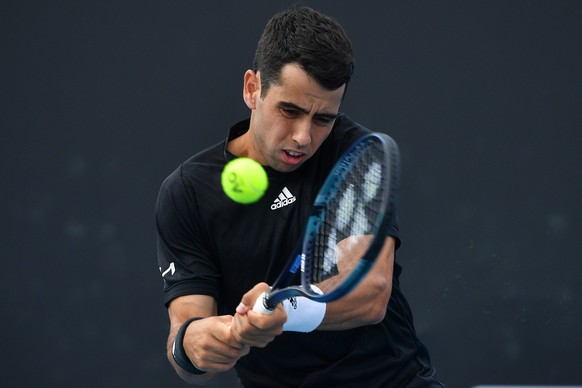 epa09665625 Jaume Munar of Spain serves during a doubles match with Rafael Nadal of Spain against Tomas Martin Etcheverry and Sebastian Baez of Argentina on Day 2 of the Melbourne Summer Set tennis to ...