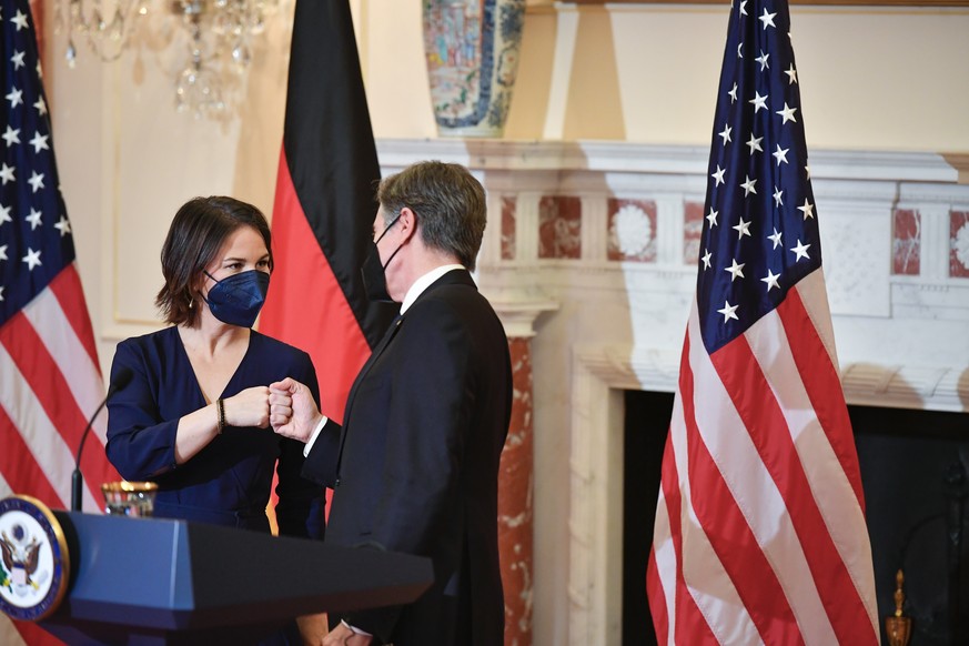 German Foreign Minister Annalena Baerbock fist bumps with Secretary of State Antony Blinken at the State Department, Wednesday, Jan. 5, 2022, in Washington. (Mandel Ngan/Pool via AP)