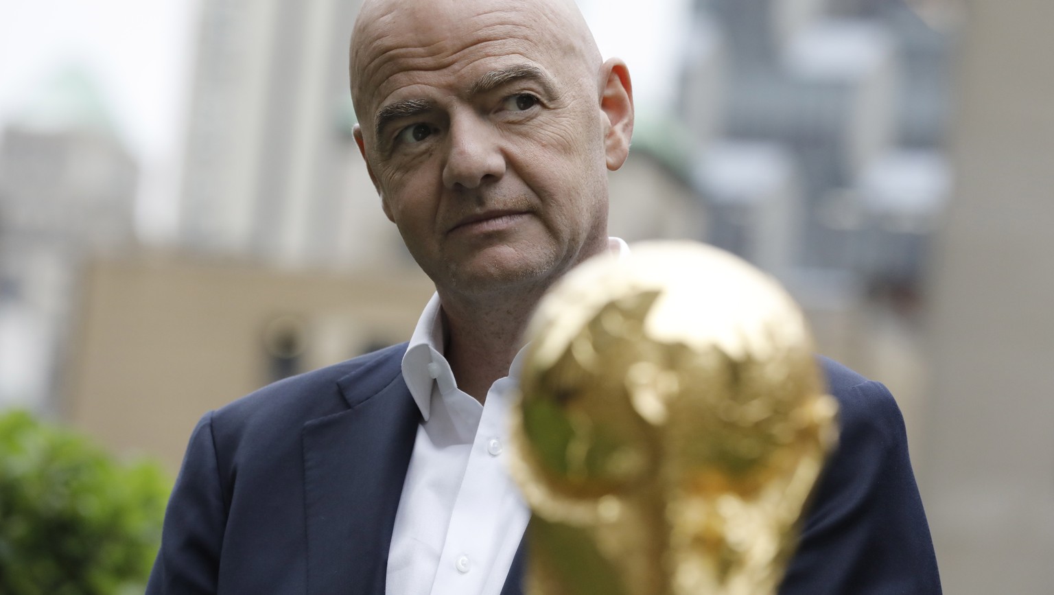 epa10017328 FIFA President Gianni Infantino, poses for photographers with the FIFA World Cup trophy at Radio City in New York, New York, USA, 16 June 2022.The North American cities hosting the 2026 Wo ...