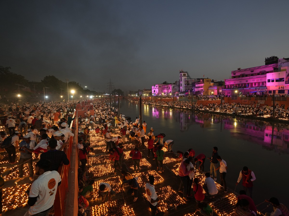 People light lamps on the banks of the river Saryu in Ayodhya, India, Sunday, Oct. 23, 2022. Over 15,00,000 earthen lamps were lit along the banks of the Saryu River, as millions of people across Asia ...