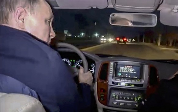 epa10532134 A still image taken from a handout video provided by the Russian President&#039;s press service on 19 March 2023 shows Russian President Vladimir Putin drives a car during his visit to Mar ...