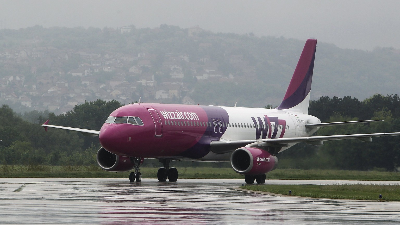 epa05950575 The plane of the low-cost airline company Wizz Air after the flight Dortmund - Nis, taxis on the tarmac at the airport Constantine the Great in Nis, Serbia, 08 May 2017. The arrival also m ...
