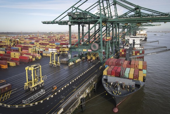 epa08986756 A container ship is unloaded at Antwerp Harbour, in Antwerp, Belgium, 04 February 2021. Due to the coronavirus pandemic, the average price for a container has almost quadrupled in a year.  ...