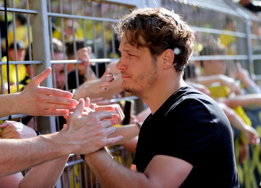 epa10657947 Dortmund head coach Edin Terzic shakes hands with fans after the German Bundesliga match between Borussia Dortmund and Mainz 05 in Dortmund, Germany, 27 May 2023. The match ended 2-2 and b ...