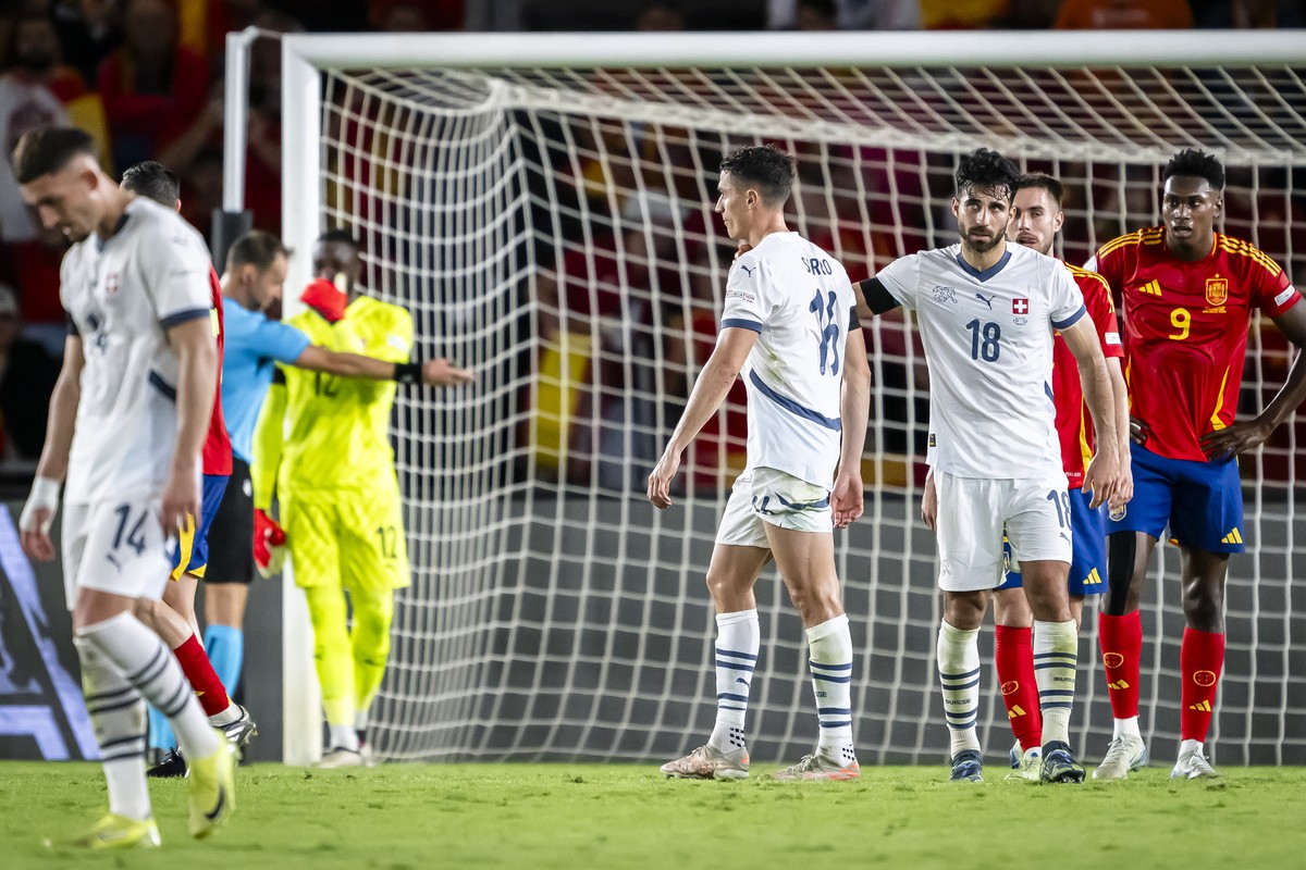 Switzerland's midfielder Vincent Sierro, center, reacts next to Switzerland's defender Eray Comert, 3rd right, during the UEFA Nations League soccer group A4 match between Spain and Switzerl ...