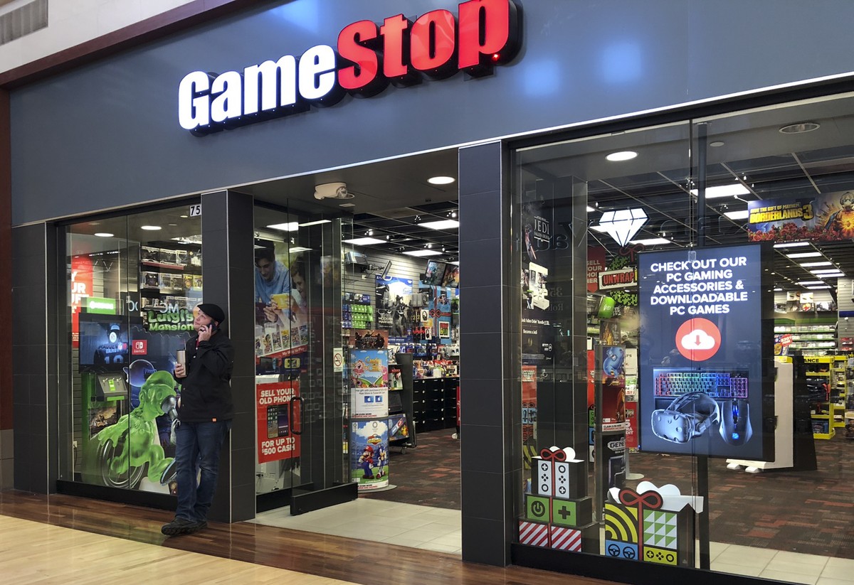 epa08971011 (FILE) - A man talks on a cell phone outside a GameStop store in Gurnee, Illinois, USA, 10 December 2019 (reissued 28 January 2021). The electronic game retailer has seen it's stock p ...