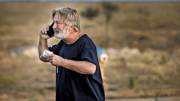 Alec Baldwin speaks on the phone in the parking lot outside the Santa Fe County Sheriff&#039;s Office in Santa Fe, N.M., after he was questioned about a shooting on the set of the film &quot;Rust&quot ...