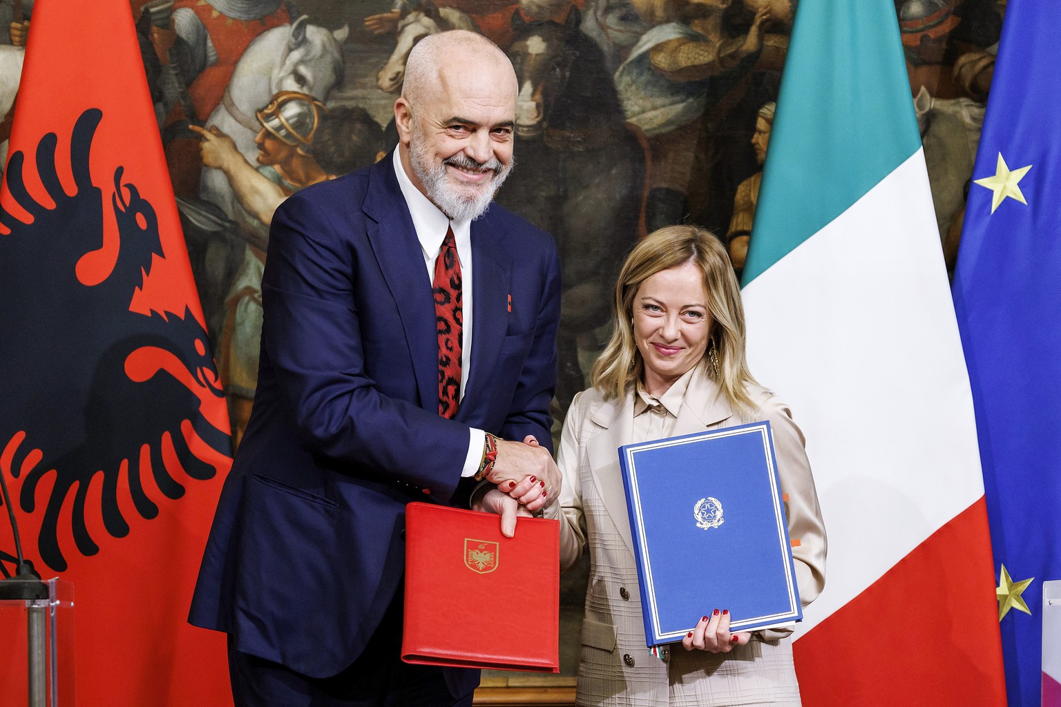 FILE - Italy&#039;s Premier Giorgia Meloni, right, and Albania&#039;s Prime Minister Edi Rama shake hands after the signing of a memorandum of understanding on migrant management centers during a meet ...