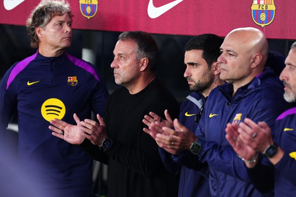 Barcelona head coach Hansi Flick, 2nd left, applauds from the bench before the Spanish La Liga soccer match between FC Barcelona and Real Madrid in Barcelona, Spain, Sunday, May 10, 2026. (AP Photo/Jo ...