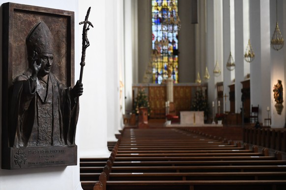 epa09712555 A relief of Pope emeritus Benedict XVI is displayed inside the Church of our Lady in Munich, Germany, 27 January 2022. An independent report investigating sexual abuse of minors through cl ...