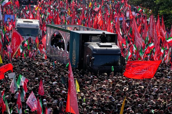 The truck carrying the coffin of the slain Iranian Supreme Leader Ayatollah Ali Khamenei makes its way along an avenue during the funeral procession in Tehran, Iran, Monday, July 6, 2026. (AP Photo/Va ...