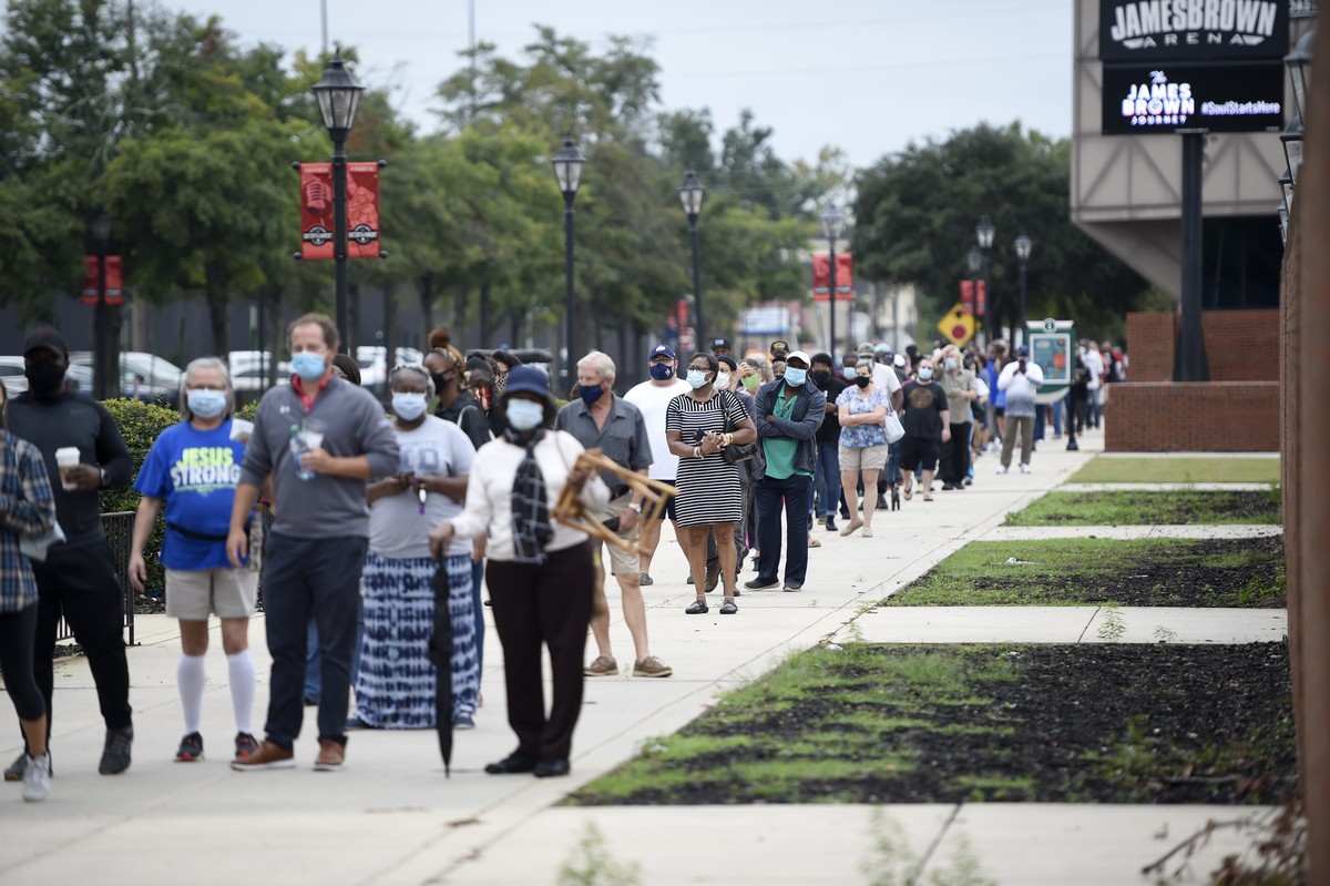 Monday was the first day for advance voting in Georgia and people showed up by the hundreds to cast their ballot early at the Bell Auditorium in Augusta, Ga., Monday, Oct. 12, 2020 (Michael Holahan/Th ...