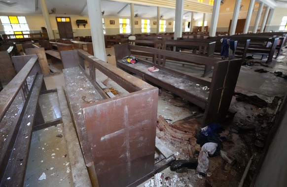 Personal belongings and shoes lie on the ground of St. Francis Catholic Church in Owo, Nigeria, Monday, June 6, 2022, a day after an attack that targeted worshipers. The gunmen who killed 50 people at ...