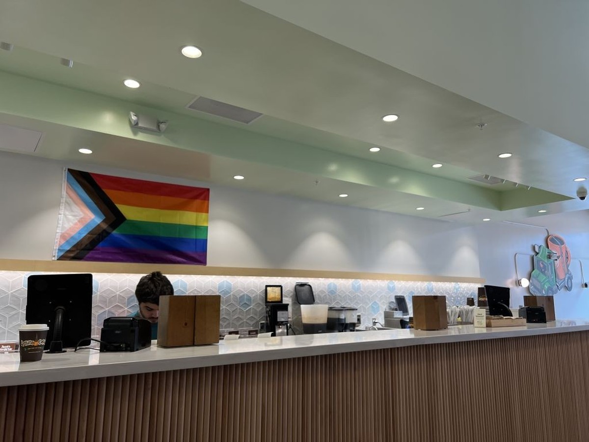 Interior of a Philz coffee shop featuring a Progress Pride flag above the counter and a well-organized workspace, Bay Street, Emeryville, California, July 29, 2024. (Photo by Smith Collection/Gado/Get ...