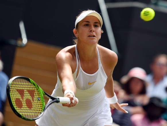 epa06875485 Belinda Bencic of Switzerland returns to Angelique Kerber of Germany in their fourth round match during the Wimbledon Championships at the All England Lawn Tennis Club, in London, Britain, ...