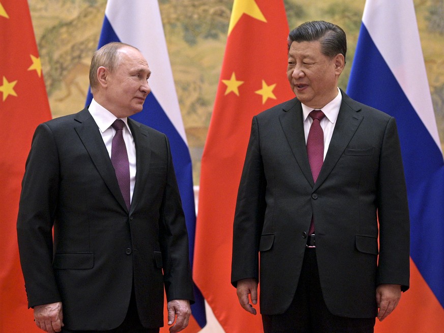 Chinese President Xi Jinping, right, and Russian President Vladimir Putin talk to each other during their meeting in Beijing, China, Friday, Feb. 4, 2022. Putin on Friday arrived in Beijing for the op ...