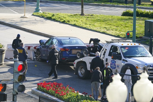 Authorities tow a car after a man rammed it into a barricade on Capitol Hill in Washington, Friday, April 2, 2021. (AP Photo/Alex Brandon)