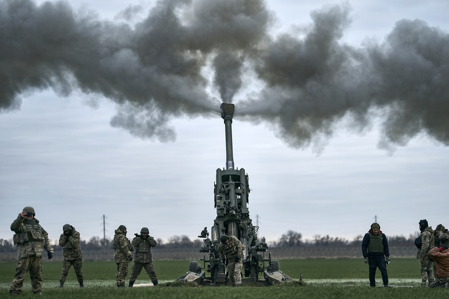 FILE - Ukrainian soldiers fire at Russian positions from a U.S.-supplied M777 howitzer in Kherson region, Ukraine, Jan. 9, 2023. A rapidly expanding group of U.S. and allied troops and contractors are ...