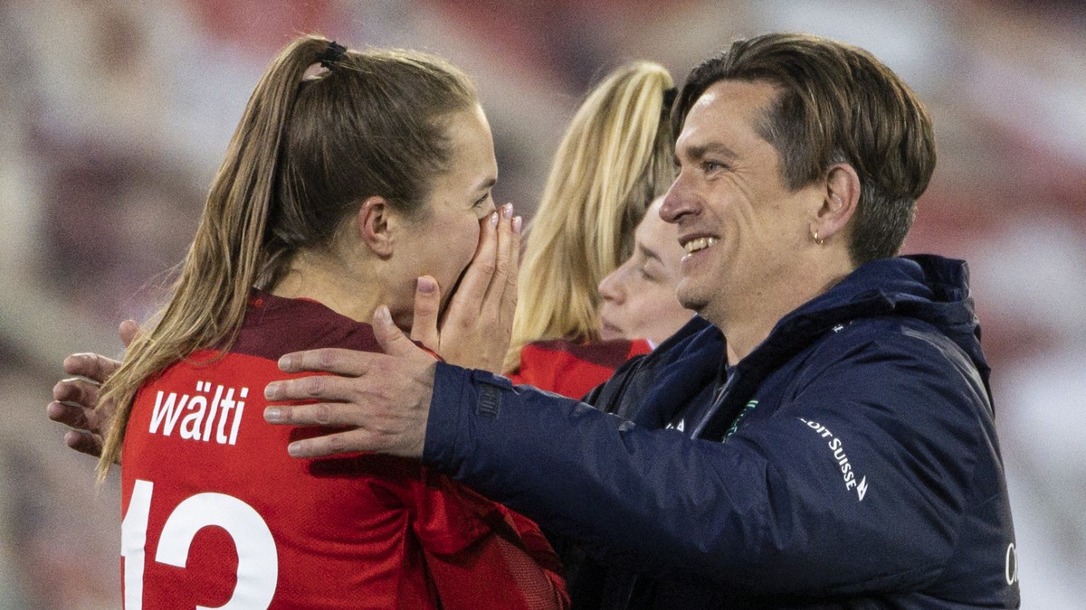 Swiss head coach Nielsen Nils, center, celebrates after with Lia Waelti, left, and Fabienne Humm, right, after winning the UEFA Women's Euro 2022 play-off 2nd leg qualification match between Swit ...