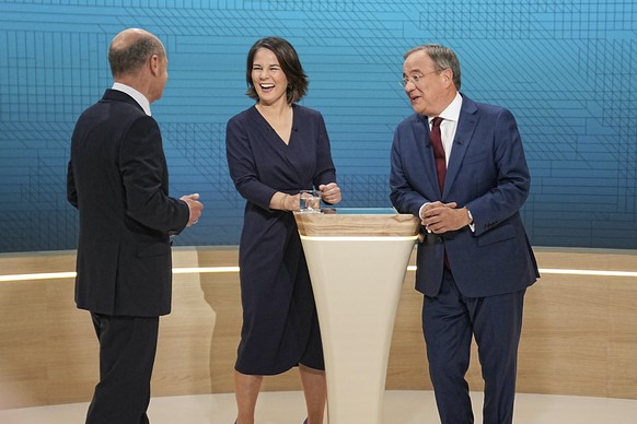 From left, Chancellor candidates Olaf Scholz (SPD), Annalena Baerbock (Green Party) and Armin Laschet (CDU) stand in the TV studio in Berlin, Sunday, Sept. 12, 2021. With two weeks left before Germany ...