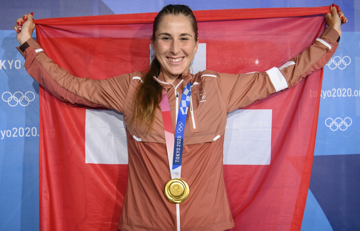 Gold medal winner Belinda Bencic of Switzerland poses with her medal and a Swiss flag after winning the games against Marketa Vondrousova of Czech Republic during the women's singles tennis gold  ...