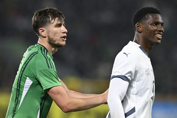 Northern Ireland&#039;s Paddy McNair, left, and Switzerland&#039;s Breel Embolo react during an international test match between Northern Ireland and Switzerland, at Windsor Park stadium in Belfast, N ...