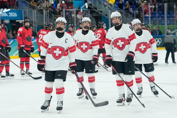 Switzerland's players are dejected afte during a semifinal match of women's ice hockey between the Canada and Switzerland at the 2026 Winter Olympics, in Milan, Italy, Monday, Feb. 16, 2026. ...