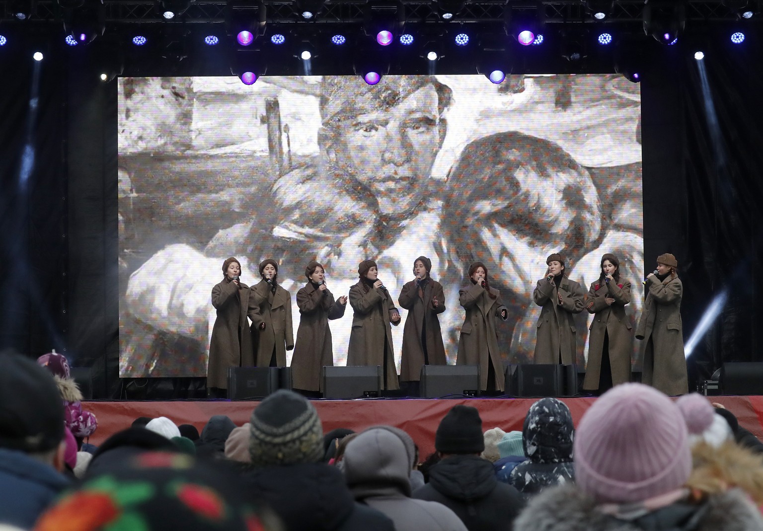 epa11108479 People listen to singers on a stage as they attend a military-historical exhibition marking the 80th anniversary of the end of the Leningrad Blockade during World War II, at the Dvortsovay ...